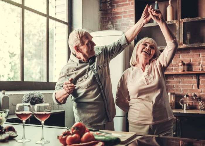 Older Couple Dancing In Kitchen
